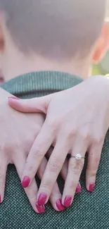 Romantic embrace showing woman's hands with an engagement ring