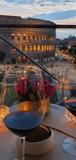 Romantic view of Colosseum with wine glasses.