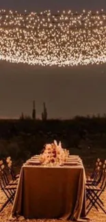 Romantic desert dining setup under twinkling string lights.