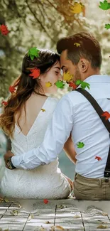 Romantic couple surrounded by autumn leaves wallpaper.