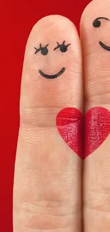 Two fingers with a red heart on a bright red background.