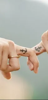 Romantic finger tattoos touching gently, symbolizing love.