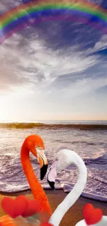 Flamingos by ocean with a rainbow in the sky and hearts on the beach.