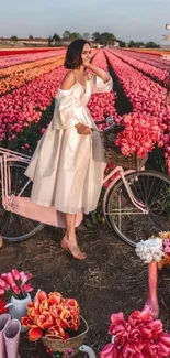 Woman on bike in pink tulip field with serene atmosphere.