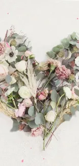 Heart-shaped floral design with pastel flowers and greenery.