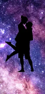 Silhouette of a couple against a vibrant galaxy backdrop with stars.