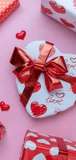 Pink background with red and white heart-shaped gifts.