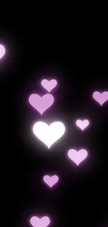 Wallpaper with glowing pink hearts on a black background.