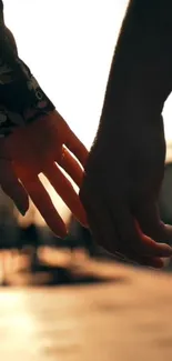 Romantic couple holding hands at sunset, creating a warm and intimate ambiance.