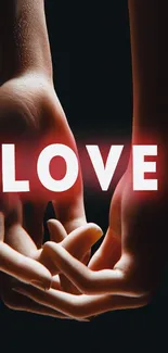 Romantic wallpaper with hands holding and glowing 'LOVE' text.