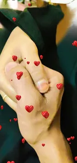 Romantic hand-holding with red hearts on a mobile wallpaper.