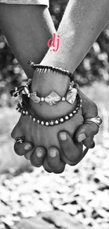 A black and white image of a couple holding hands.