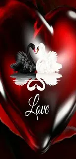 Red glossy heart with two swans and love text on a wallpaper.