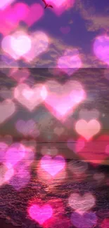 Romantic beach sunset with pink hearts bokeh wallpaper.