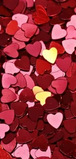 Colorful heart confetti design wallpaper in red, pink, and yellow hues.