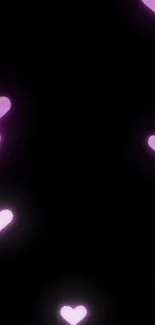 Mobile wallpaper with glowing pink hearts on a black background.