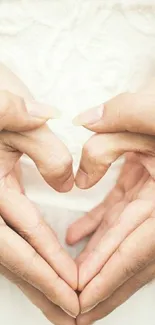 Romantic heart hands forming a heart symbol against a soft background.