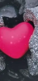 Bright pink heart surrounded by glittering stones on a dark background.