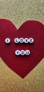 Mobile wallpaper with red heart and 'I Love You' beads on golden background.