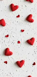 Mobile wallpaper with red hearts on white textured background.