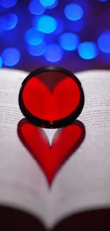 Romantic heart reflection on open book with blue background lighting.