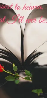 Heart-shaped book pages with a red rose.