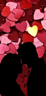 Silhouette of couple with heart backdrop.