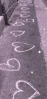 Purple pavement with white chalk hearts artfully drawn.