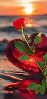 Red heart and rose at sunset on a beach.