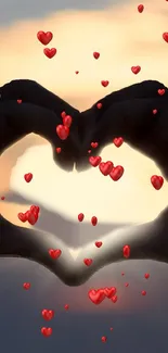 Heart hands silhouette with red hearts at sunset.