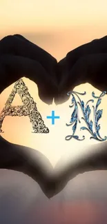 Romantic heart hands silhouette with ornate letters A and N at sunset.