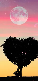 Silhouette under heart-shaped tree with moonlit sky wallpaper.