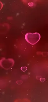 Glowing pink hearts on deep red background mobile wallpaper.