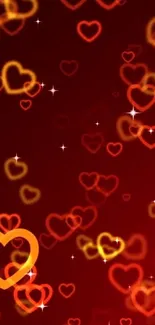 Vibrant mobile wallpaper with red and orange glowing hearts and sparkling accents.