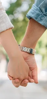 Couple holding hands on a serene day.