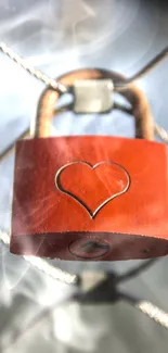 Heart-engraved padlock on chain link fence.