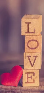 Wooden love blocks with a red heart.