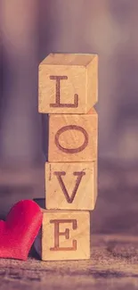 Wooden blocks spelling 'LOVE' with a red heart on a rustic background.