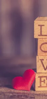 Wooden blocks spelling love with red heart.