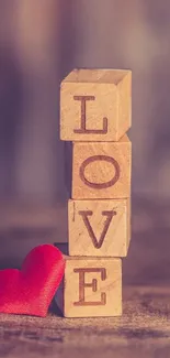 Wooden blocks spell LOVE with a red heart.