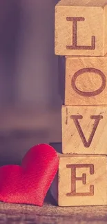 Wooden blocks spelling 'LOVE' with a red heart.