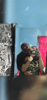 Couple's reflection in mirror with anime art and pink curtain.