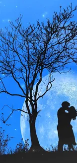 Silhouette of a couple kissing under a large moon with a blue background.