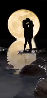 Silhouette couple embracing by moonlit water under a full moon.