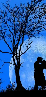 Romantic couple silhouette under moonlit sky with tree.