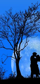 Silhouette of couple kissing under full moon in blue night sky.