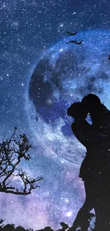 Silhouette of couple kissing under a moonlit night sky.