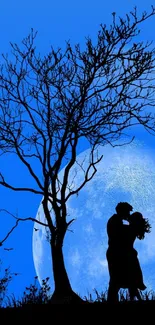 Silhouetted couple kiss under a blue moonlit sky.