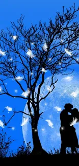 Silhouette of a couple under a tree with moonlit background.