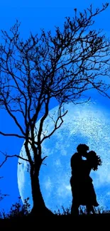 Silhouetted couple kissing under a blue moonlit sky.